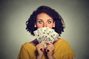 woman-holding-money-in-front-of-face