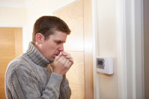 cold-man-in-front-of-thermostat